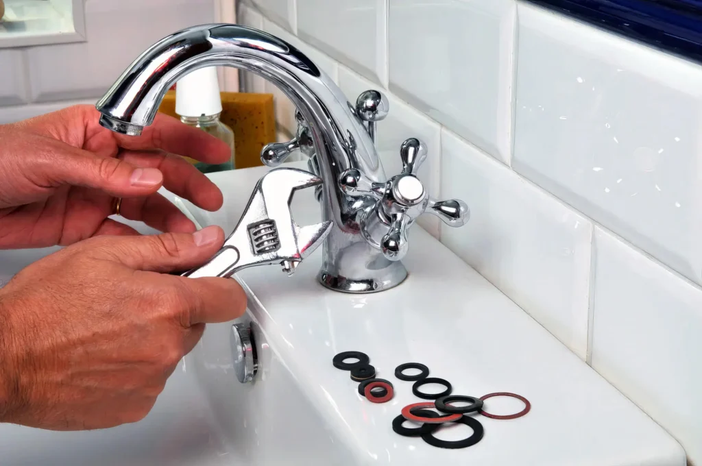 Plumber performing maintenance on a bathroom faucet in Lemon Grove